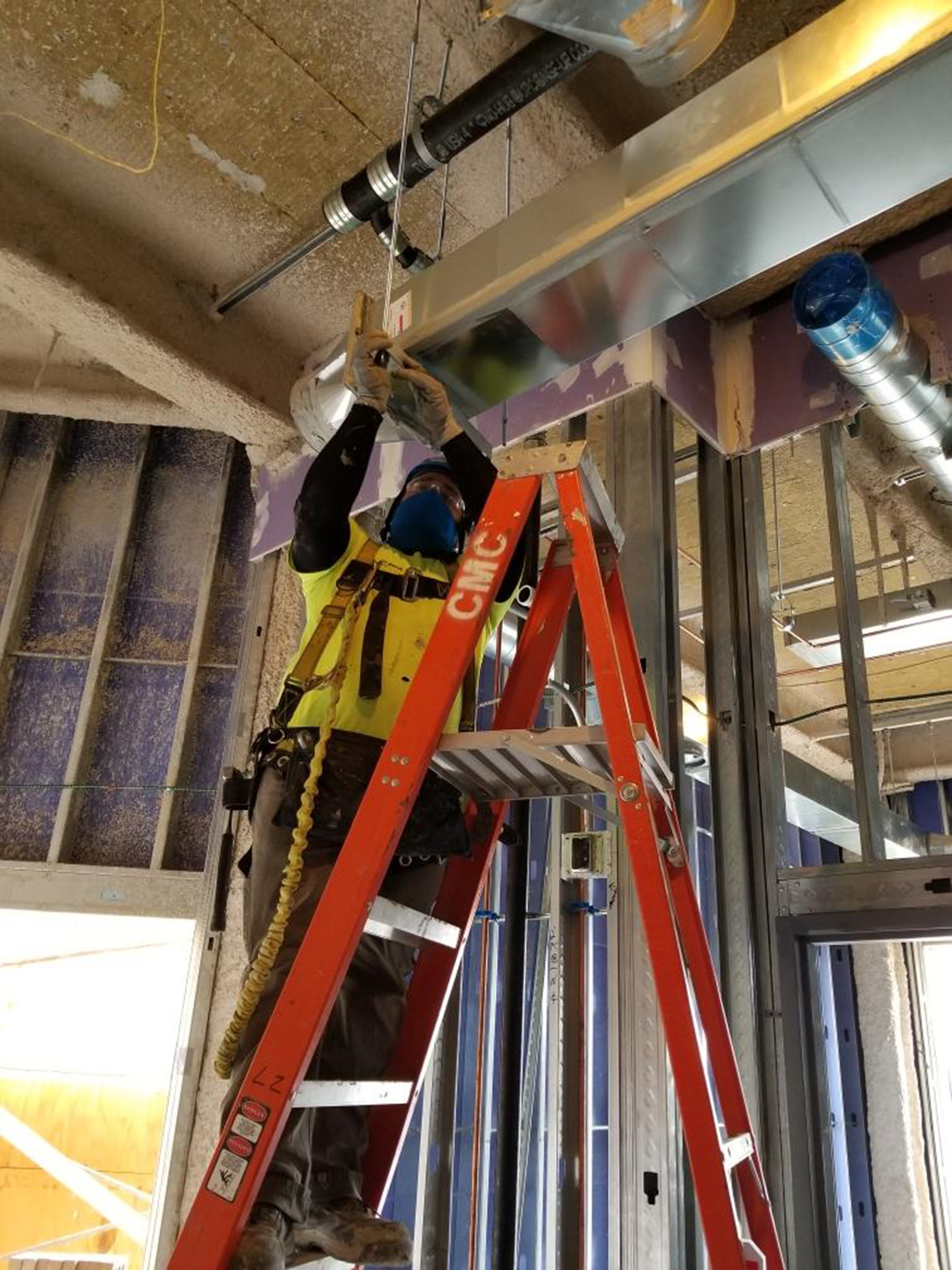 Pic9 Field - On Ladder Adjusting Duct Hanger