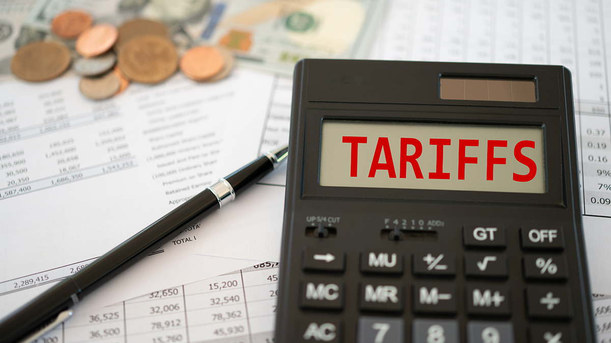 Tariffs word on calculator screen with Invoice and export